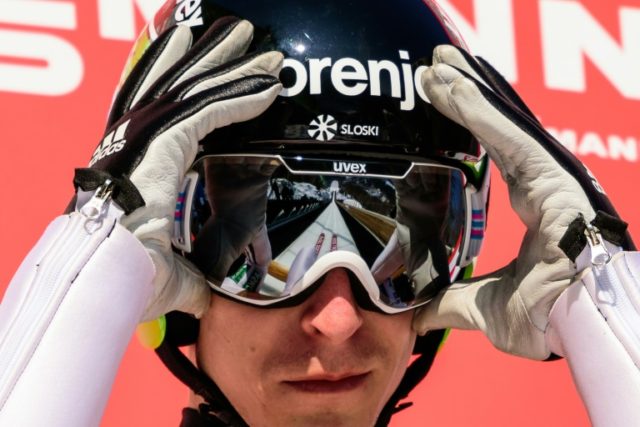 The Planica ski jumping hill is reflected in the goggles of Slovenia's Jurij Tepes as he p