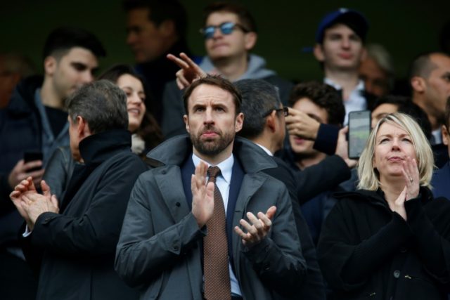England manager Gareth Southgate (C) attends the English Premier League football match bet