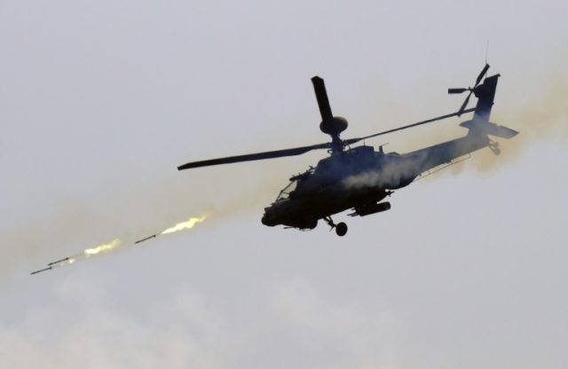 A US-made AH-64E Apache helicopter launches rockets during a live-fire drill in southern P