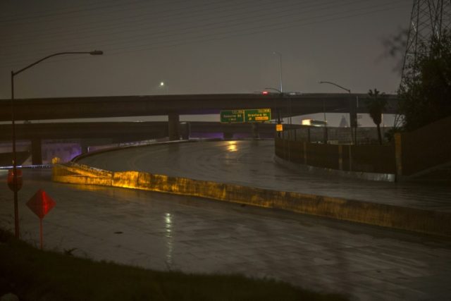A busy freeway is shut down in both direction due to flooding as a powerful storm moves ac