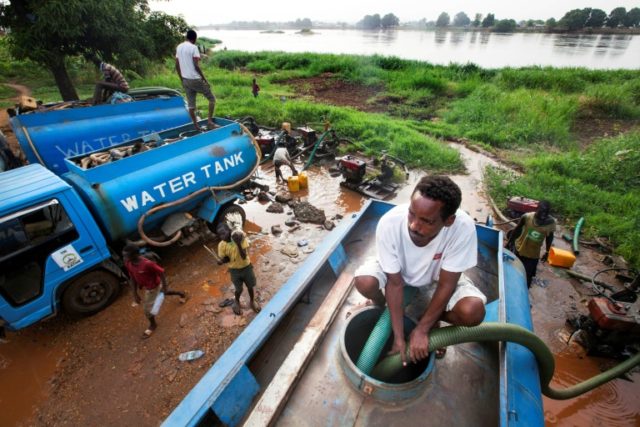 Truck drivers collect water directly from the Nile river to distribute to residents in Jub