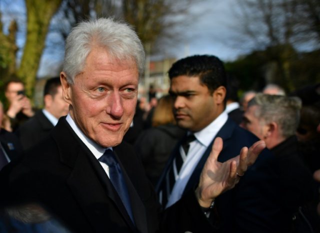 Former US President Bill Clinton speaks to mourners after the funeral of former Northern I