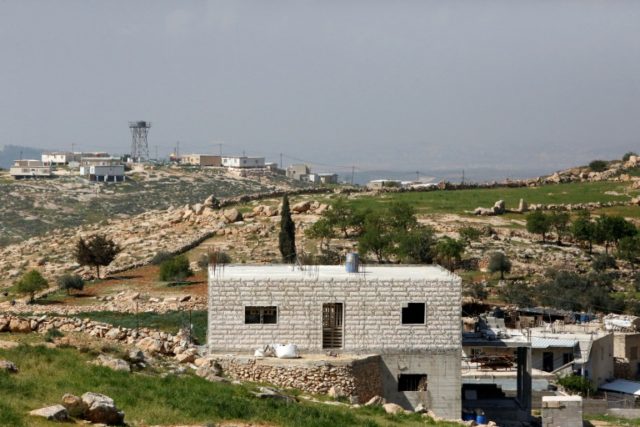 The Israeli settlement of Asael in seen in the background of the Palestinian village of Ra