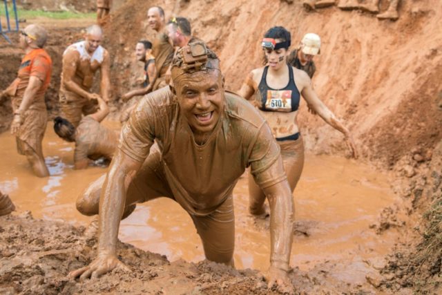 Contestants take part in the Mud Day race, a 13- kilometre (eight-mile) obstacle course, o