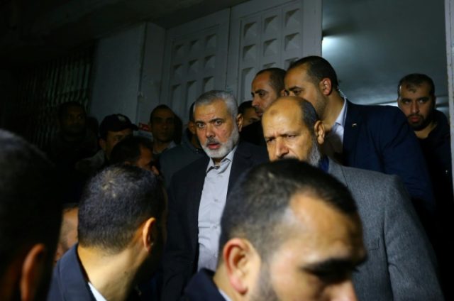 Senior Hamas leader Ismail Haniya (C) leaves a hospital morgue in Gaza City on March 24, 2