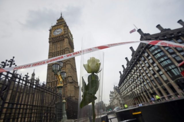 A flower left in tribute to the victims of the London March 22 terror attack placed next t