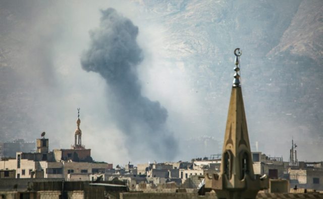 Smoke rises from buildings following an air strike on Jobar, a rebel-held district on the