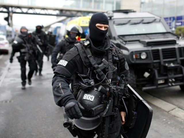 RAID police unit officers secure the area at the Paris' Orly airport on March 18, 2017 following the shooting of a man by French security forces