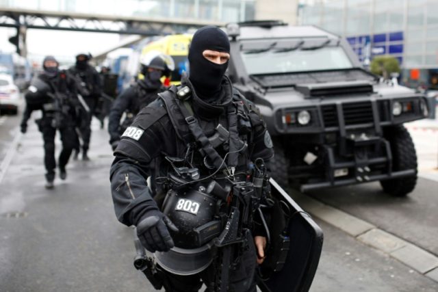RAID police unit officers secure the area at the Paris' Orly airport on March 18, 2017 fol