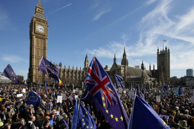 Demonstrators holding EU and Union flags gather in front of the Houses of Parliament in Lo