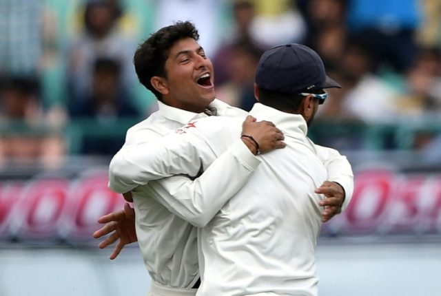 India's Kuldeep Yadav (L) celebrates the wicket of Australia's Peter Handscomb with teamma