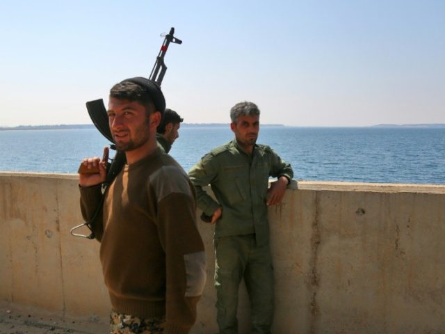 Members of the US-backed Syrian Democratic Forces (SDF) at the Taqba Dam on March 28, 201