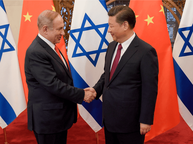 Israeli Prime Minister Benjamin Netanyahu, left, is greeted by Chinese President Xi Jinping ahead of their talks at Diaoyutai State Guesthouse Tuesday, March 21, 2017 in Beijing, China. (Etienne Oliveau/Pool Photo via AP)