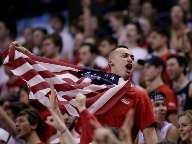 A fan in the Gonzaga student section wears an American flag before an NCAA college basketb