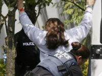 A policewoman is shown searching a woman outside of the Fresh Del Monte Produce fruit and vegetable processing plant on June 12, 2007, in Portland, Ore. Fictitious Social Security numbers and green cards are cheap and widely available, and getting them is the first step for many undocumented immigrants arriving …