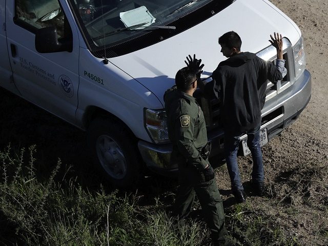 In this Wednesday, Nov. 16, 2016, photo, a U.S. Customs and Border Patrol agent works with