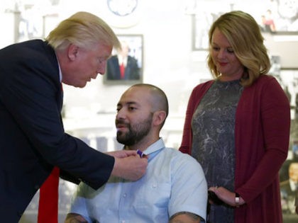 President Donald Trump awards a Purple Heart to U.S. Army Sgt. First Class Alvaro Barrient