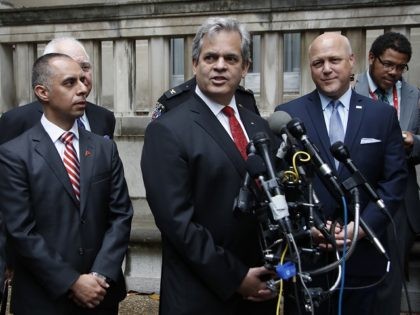 Austin, Texas Mayor Steve Adler, center, with, from left, Columbia, S.C. Mayor Steve Benja