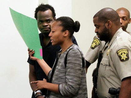 Basil Eleby is escorted by his public defender and two Fulton County Sheriff's office offi