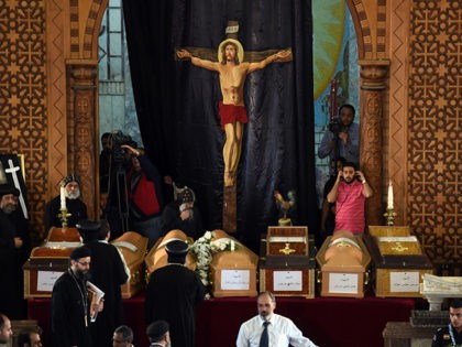 Coptic priests stand near the coffins of victims of the blast at the Coptic Christian Saint Mark's church in Alexandria the previous day during a funeral procession at the Monastery of Marmina in the city of Borg El-Arab, east of the northern port city on April 10, 2017. Egypt prepared …