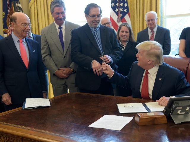 President Donald Trump hands United Steel Workers International President Leo W. Gerard th
