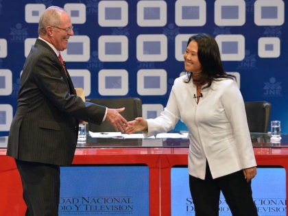 Peruvian presidential candidate for the Fuerza Popular (Popular Strength) party Keiko Fujimori (R) shakes hands with Peruvian presidential candidate Pedro Pablo Kuczynski of the "Peruanos por el Kambio" (Peruvians for change) party before a televised debate in Lima on May 29, 2016. Fujimori and Kuczynski will compete in Peru's June …