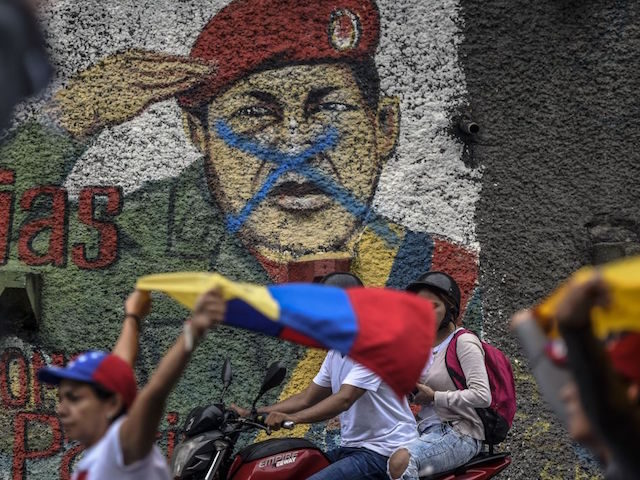 Venezuelan opposition activists march during a protest against President Nicolas Maduro's government, in Caracas on April 13, 2017. A 32-year-old man died Thursday after being shot and wounded in a demonstration on April 11, becoming the fifth victim in the protests that began almost two weeks ago. Dozens of people …