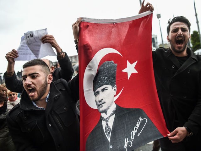 TOPSHOT - Supporters of the "No voters" and members of Turkey's main opposition party, the Republican People's Party (CHP), hold a flag of Mustafa Kemal Ataturk, founder of modern Turkey as they gather at the Caglayan courthourse to submit their petition to object alleged irregularities in Turkish vote on April …