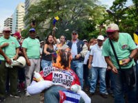 VENEZUELA-OPPOSITION-PROTEST Demonstrators burn an effigy of President Nicolas Maduro during a protest at the east side of Caracas on April 19, 2017.