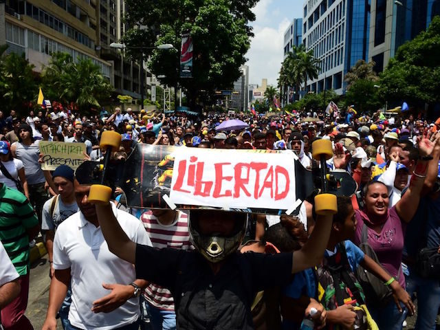 People demonstrate against Venezuelan President Nicolas Maduro, in Caracas on April 20, 2017. Venezuelan riot police fired tear gas Thursday at groups of protesters seeking to oust President Nicolas Maduro, who have vowed new mass marches after a day of deadly unrest. Police in western Caracas broke up scores of …