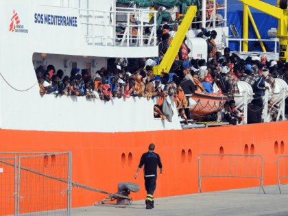 Would be immigrants wait to disembark in the port of Catania, on the island of Sicily on March 21, 2017 from the ship 'Aquarius' following a rescue operation in the Mediterranean sea, where some 946 would be immigrants have been rescued.