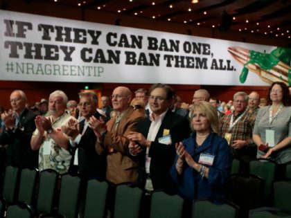 People applaud a speaker at the National Rifle Association convention Friday, April 10, 20