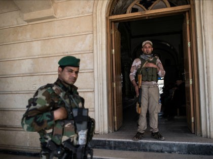 MOSUL, IRAQ - APRIL 16: Syriac Christian militiamen guard Saint John's Church (Mar Yohanna) during an easter ceremony in the nearly deserted predominantly Christian Iraqi town of Qaraqosh on April 16, 2017 near Mosul, Iraq. Qaraqosh was retaken by Iraqi forces in 2016 during the offensive to capture the nearby …