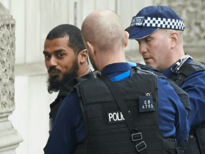 Firearms officiers from the British police detain a man on Whitehall near the Houses of Parliament in central London on April 27, 2017 before being taken away by police.