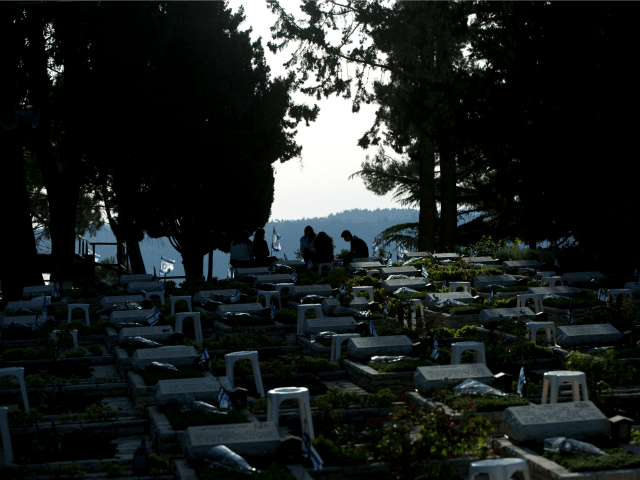 Israelis visits the graves of fallen soldiers on the eve of memorial Day at the military c