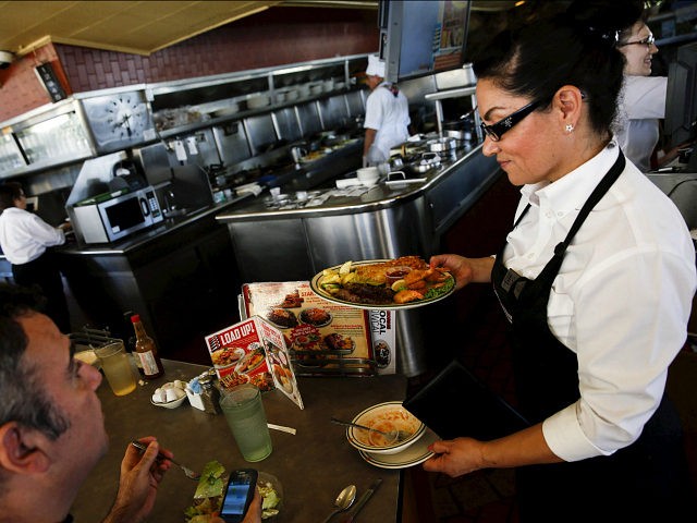 A waitress serves a steak and fried shrimp combo plate to a customer at Norms Diner on La Cienega Boulevard in Los Angeles, California May 20, 2015. REUTERS/Patrick T. Fallon