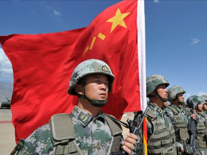 A Chinese soldier holds a Chinese flag during Peace Mission-2016 joint military exercises of the Shanghai Cooperation Organization (SCO) in the Edelweiss training area in Balykchy some 200 km from Bishkek on September 19, 2016. The joint anti-terrorism drill involves more than 1,100 troops of Russia, Kazakhstan, Kyrgyzstan, Tajikistan, Uzbekistan …