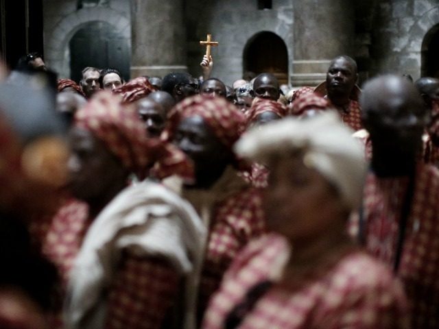 Nigerian pilgrims wait outside the Tomb of Jesus during their visit at the Holy Sepulchre in Jerusalem's Old City on February 25, 2016. / AFP / THOMAS COEX (Photo credit should read THOMAS COEX/AFP/Getty Images)