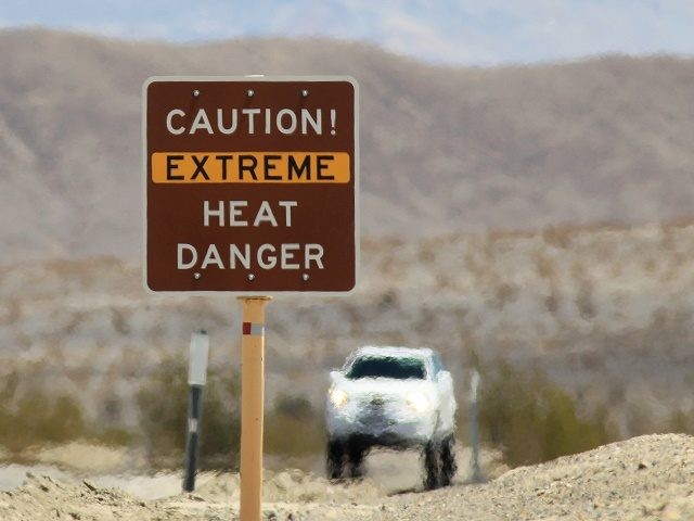 DEATH VALLEY NATIONAL PARK, CA JULY 14: Heat waves rise near a heat danger warning sign on the eve of the AdventurCORPS Badwater 135 ultra-marathon race on July 14, 2013 in Death Valley National Park, California. Billed as the toughest footrace in the world, the 36th annual Badwater 135 starts …