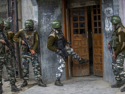 Indian paramilitary soldiers kick open the door of a hotel before entering it, after a suspect was arrested from the hotel, in Srinagar, Indian controlled Kashmir, Saturday, April 1, 2017. Government forces fired in the air and used tear gas to disperse hundreds of youths who came out on the …