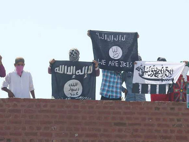 SRINAGAR, INDIA - AUGUST 28: Masked Kashmiri youth hold ISIS, Lashkar-e-Taiba flags and po