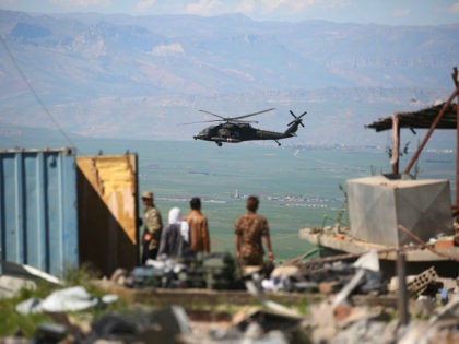 TOPSHOT - A medical helicopter, from the US-led coalition, flies over the site of Turkish airstrikes near northeastern Syrian Kurdish town of Derik, known as al-Malikiyah in Arabic, on April 25, 2017. Turkish warplanes killed more than 20 Kurdish fighters in strikes in Syria and Iraq, where the Kurds are …