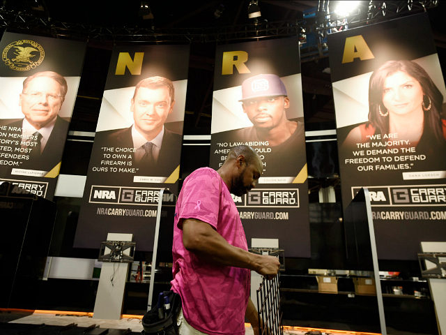 Be Ware, of Atlanta works on a vendor booth ahead of the NRA convention, Thursday, April 2