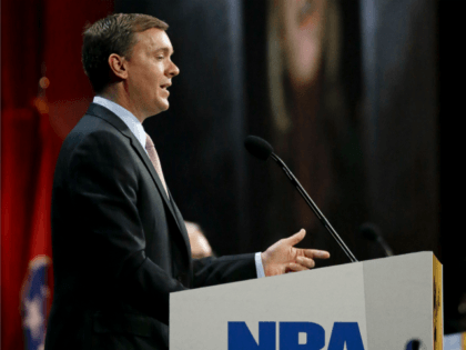Chris Cox, executive director of the Institute for Legislative Action, the political and lobbying arm of the National Rifle Association, speaks during the annual meeting of members at the NRA convention Saturday, April 11, 2015, in Nashville, Tenn. Projected on a screen behind Cox is a picture of former Secretary …