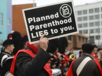 Anti-abortion protestors gather at a demonstration outside a Planned Parenthood office on