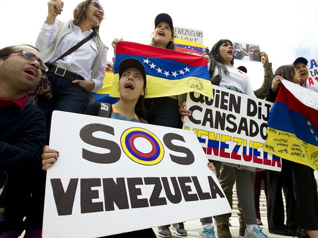 Demonstrators who are against the Venezuelan government chant outside of the Organization