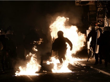 A molotov cocktail thrown by protesters explodes in front of riot police in the central district of Exarchia in Athens, on December 6, 2016, following a commemorative rally marking the eighth anniversary of the killing of teenager Alexandros Grigoropoulos by a Greek police officer. Hundreds of pupils, university students and …