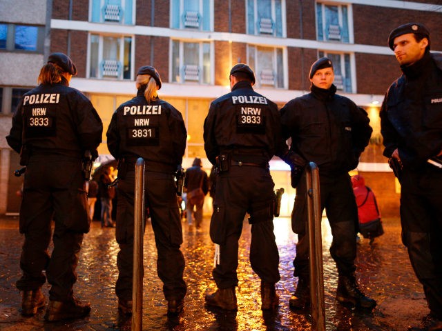 Police officers stand in front of the Senators Hotel in Cologne, western Germany on March