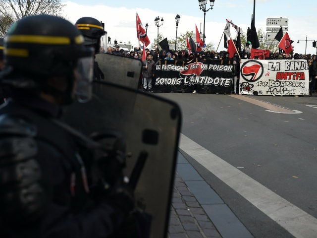 TOPSHOT - French anti-riot police look on during a demonstration against French far-right