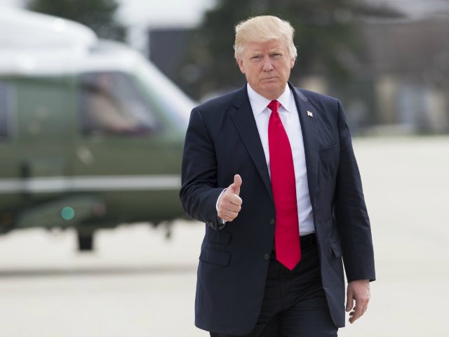 US President Donald Trump gives a thumbs-up as he walks to Marine One at General Mitchell Internati